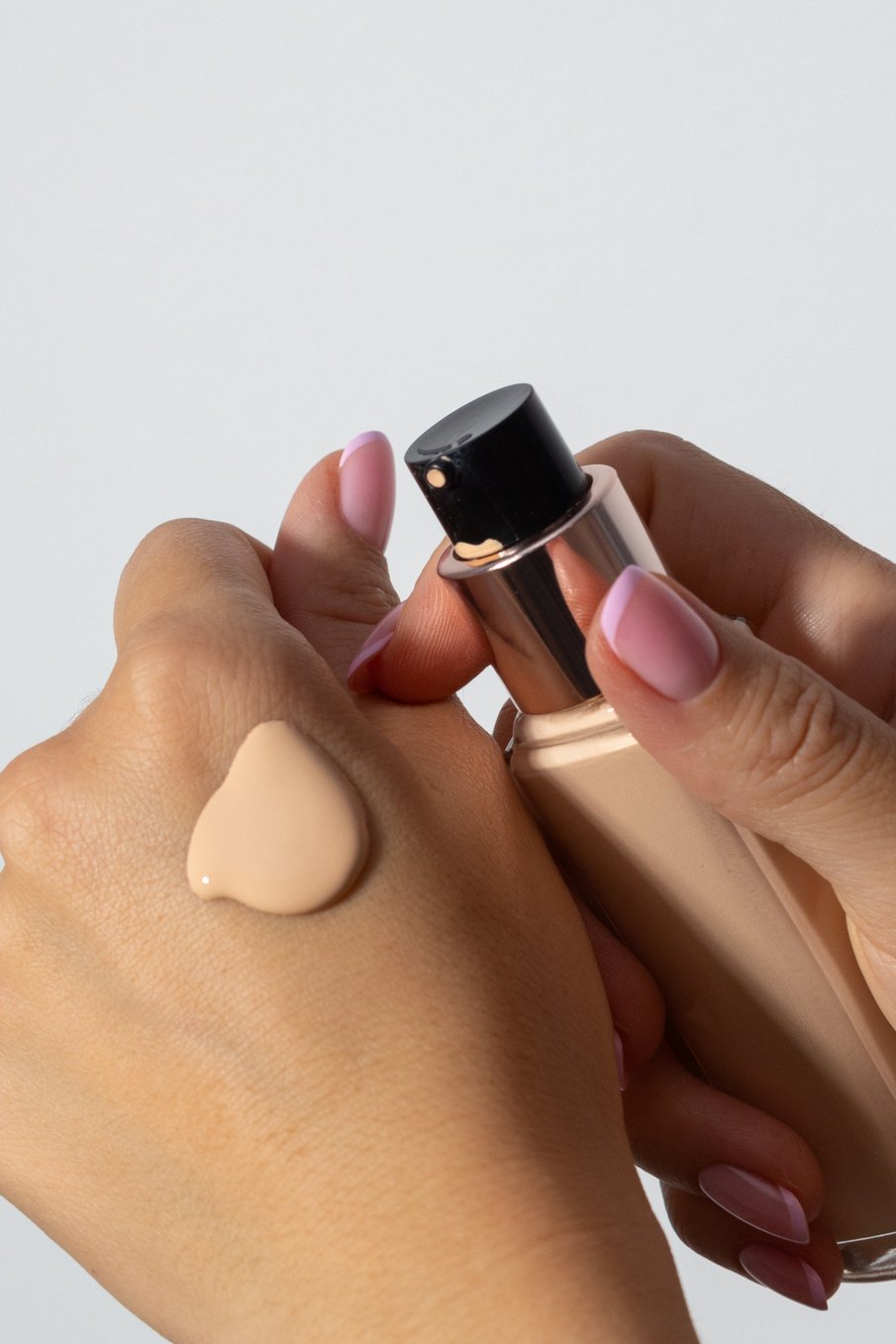 Person Applying Liquid Foundation on Hand